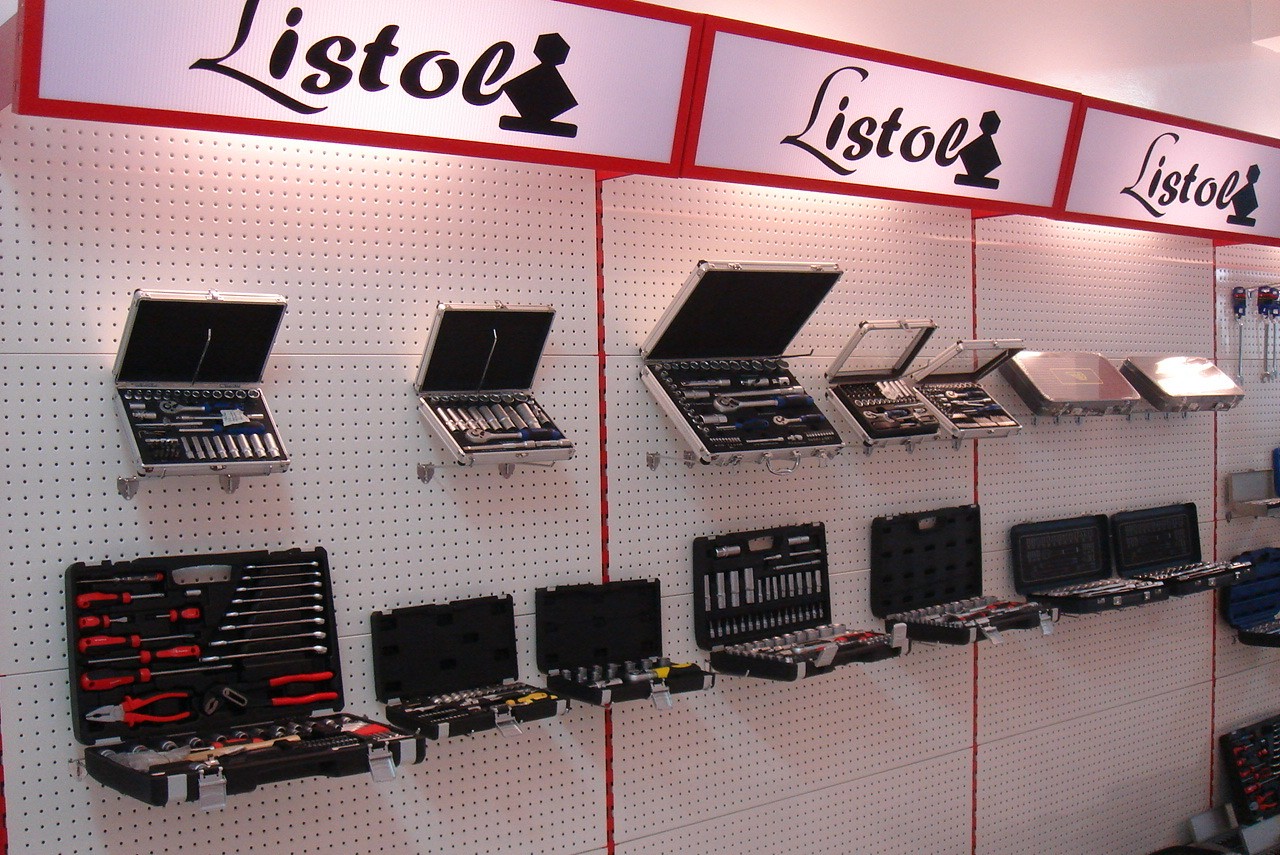 Open tool cases and hand tools displayed on a trade-show pegboard wall